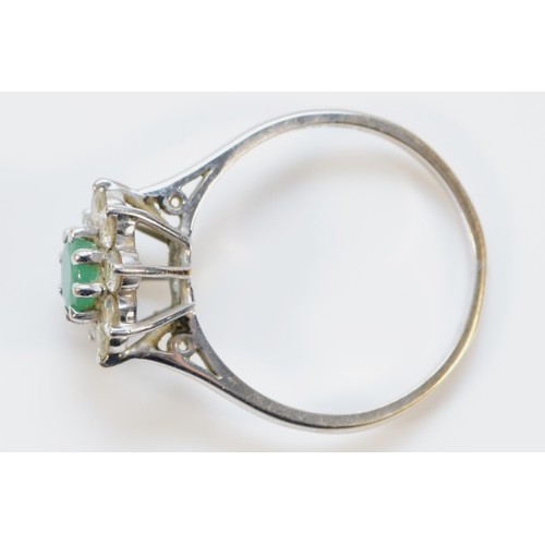 101 - An 18ct white gold, brilliant cut diamond and emerald floral cluster ring, R, 3.6g