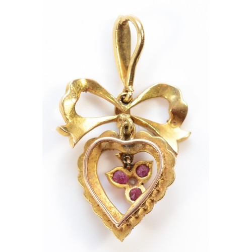 125 - An unmarked Victorian 15ct gold seed pearl, ruby and diamond heart and bow pendant, 30mm, 3g