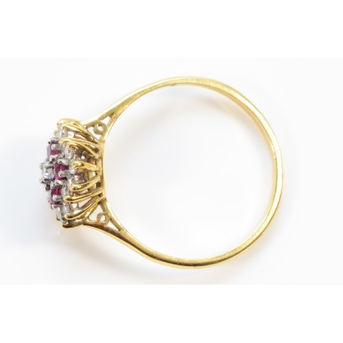 135 - An 18ct gold ruby and brilliant cut diamond cluster ring, X, 4.1g