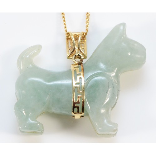 142 - A 14K gold jadeite pendant of a dog, stamped WW China, 33mm across, 12.8g