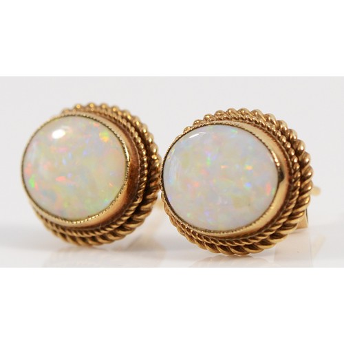 144 - A pair of 9ct gold opal earrings with scroll backs, 10mm x 6mm opals, good colour play, 2.3g