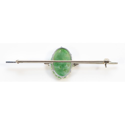 159 - A 9ct white gold floral carved jade Art Deco brooch, 65mm across, 6g