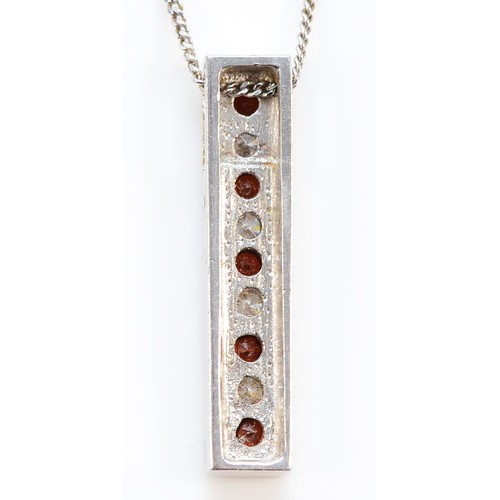 180 - A 9ct white gold red gemstone and brilliant cut diamond drop pendant, 25mm drop, 3.7g