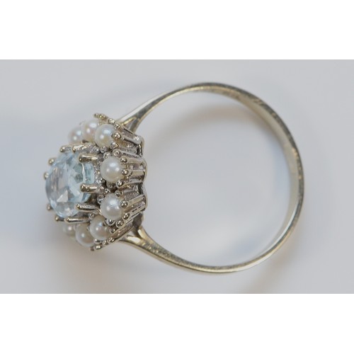 194 - A 585 white gold blue gemstone and seed pearl cluster ring, probably aquamarine to the centre of the... 