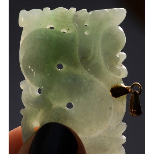 195 - A 14K carved jade pendant in the form of a Chinese dragon, 35mm, 13.4g