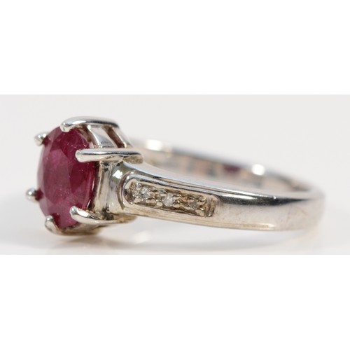 196 - A 9ct white gold ruby solitaire ring with diamond set shoulders, N, 3.4g