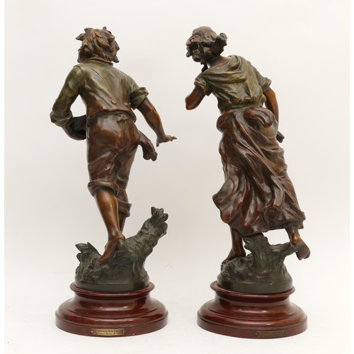 256 - After L & F Moreau (1832-1927); a pair of bronzed spelter figurines, one depicting a young boy holdi... 