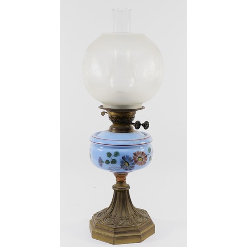 261 - An Edwardian oil lamp with a Duplex English burner, a light blue glass reservoir decorated with blue... 