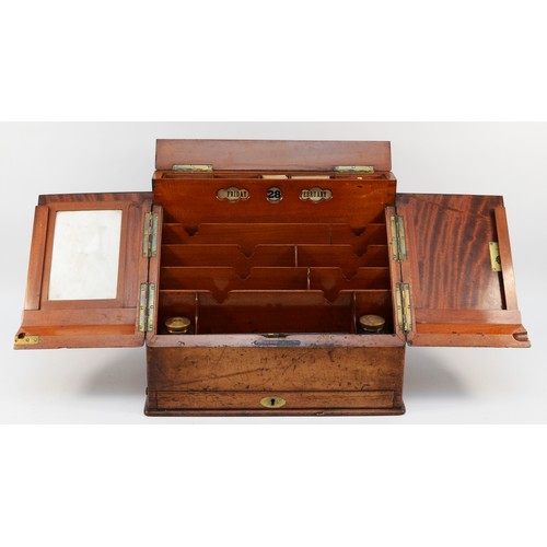 265 - A late Victorian walnut stationary box, the sloping hinged top revealing pigeon holes, two inkwells,... 