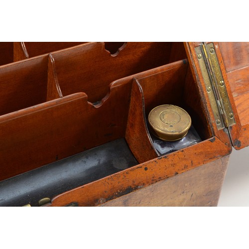 265 - A late Victorian walnut stationary box, the sloping hinged top revealing pigeon holes, two inkwells,... 