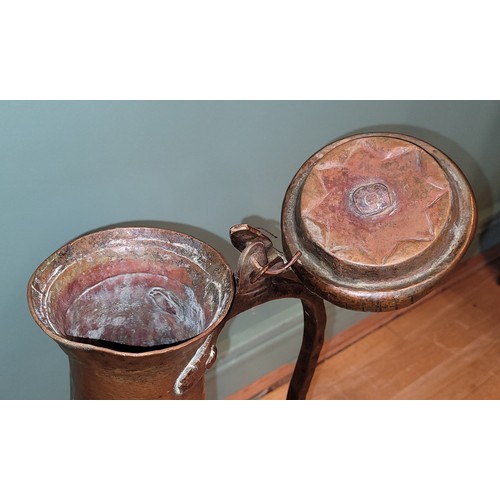 267 - A Persian copper ewer, 76cm, together with a freestanding gilt cast-metal plant stand, with scrollin... 