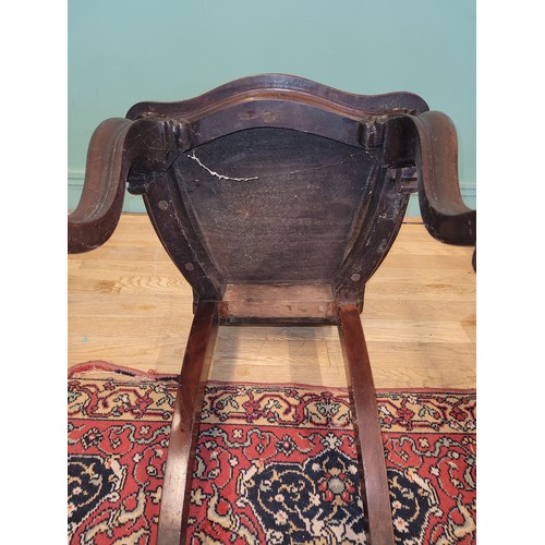 378 - A Victorian mahogany hall chair, the deeply carved scroll back with solid seat, raised on cariole le... 