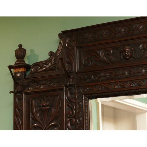 379 - A Victorian profusely carved oak hall-stand, the moulded cornice with foliate carved decoration over... 