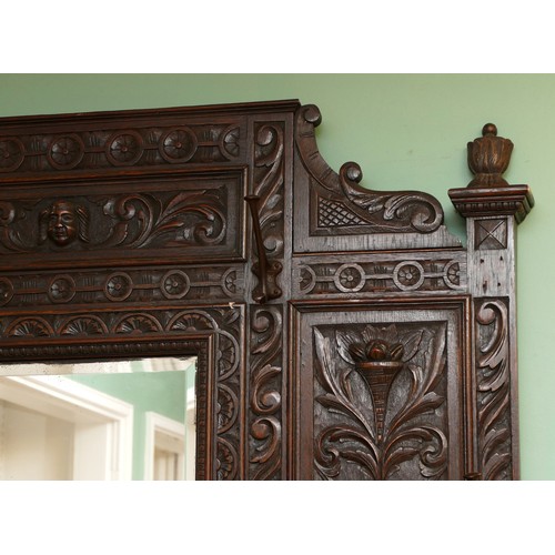 379 - A Victorian profusely carved oak hall-stand, the moulded cornice with foliate carved decoration over... 