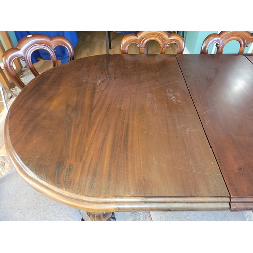 382 - A 20th Century mahogany dining suite, comprising wind-out dining table, having moulded edge circular... 