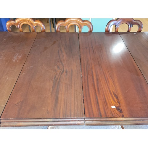 382 - A 20th Century mahogany dining suite, comprising wind-out dining table, having moulded edge circular... 