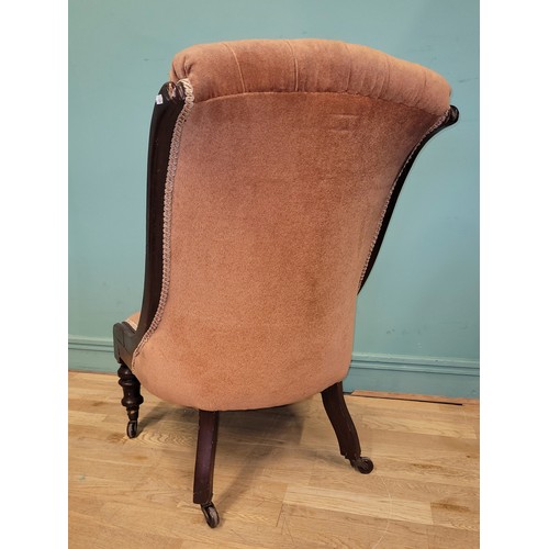 374 - A Victorian spoon back armchair, having scroll arm terminals the button back upholstered in pale pin... 