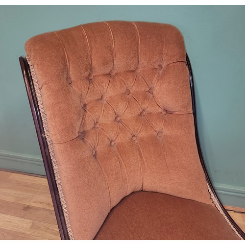 374 - A Victorian spoon back armchair, having scroll arm terminals the button back upholstered in pale pin... 