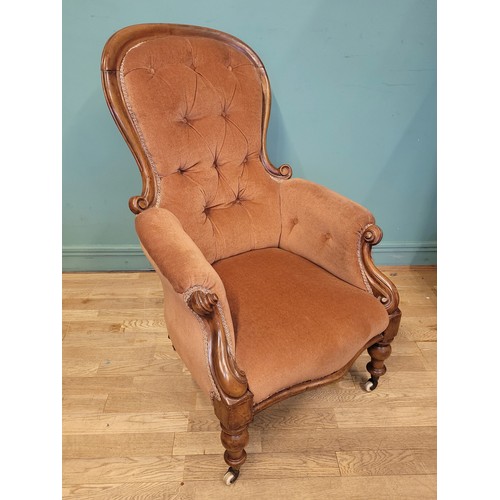 375 - A Victorian mahogany nursing chair, having buttoned pale pink upholstery, raised on turned legs with... 