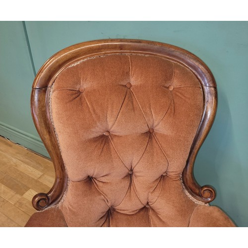 375 - A Victorian mahogany nursing chair, having buttoned pale pink upholstery, raised on turned legs with... 