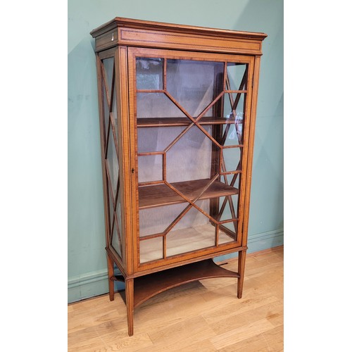 377 - An Edwardian inlaid mahogany and satinwood display cabinet, having single glazed door opening to fit... 