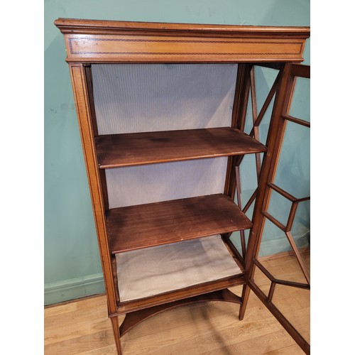 377 - An Edwardian inlaid mahogany and satinwood display cabinet, having single glazed door opening to fit... 