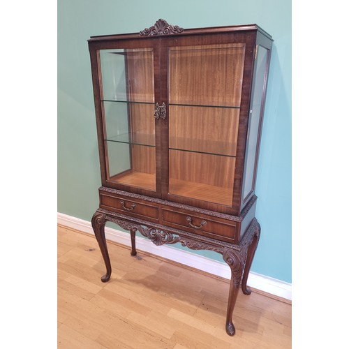 380 - A Queen Anne style mahogany display cabinet, having two bevel edge glazed doors enclosing two glass ... 