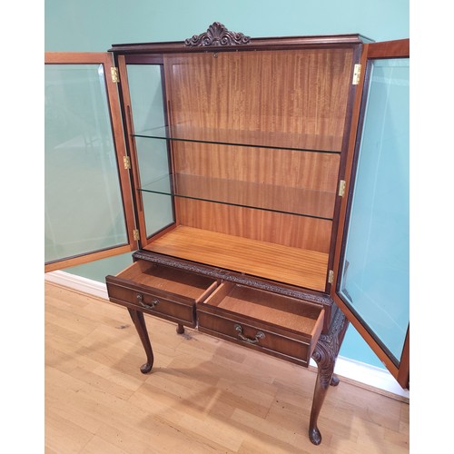 380 - A Queen Anne style mahogany display cabinet, having two bevel edge glazed doors enclosing two glass ... 