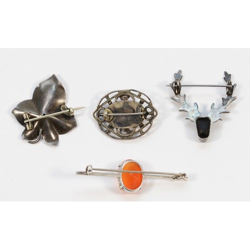 21 - Four sterling silver brooches, including one in the shape of a stags head and a leaf, 16g