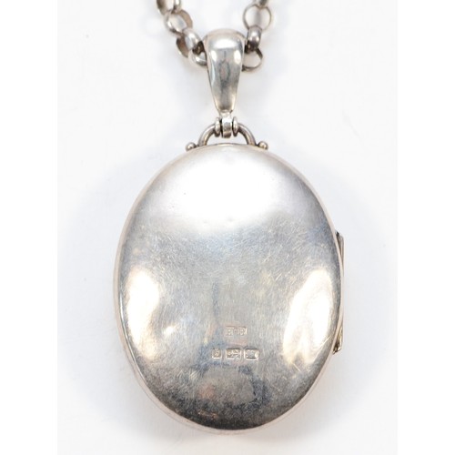 40 - A Victorian silver locket with a chain, Birmingham 1882, 43mm x 33mm, 38g