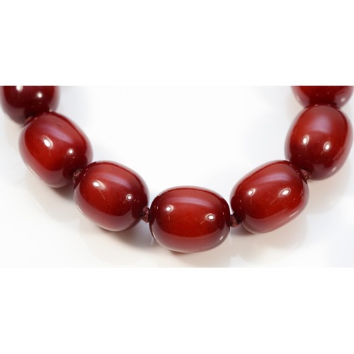 55 - A cherry amber Bakelite beaded necklace with matching hook earrings, 20mm beads, 175g