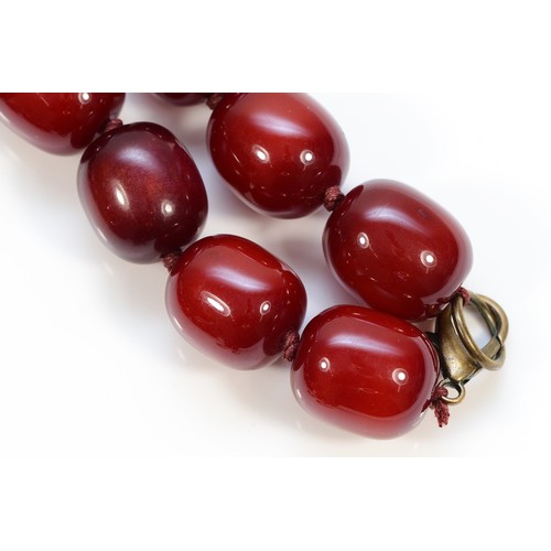 55 - A cherry amber Bakelite beaded necklace with matching hook earrings, 20mm beads, 175g