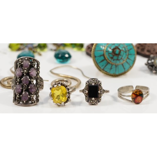 56 - Four silver rings to include marcasite and amethyst, marcasite and black onyx and yellow gemstone, t... 