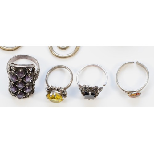 56 - Four silver rings to include marcasite and amethyst, marcasite and black onyx and yellow gemstone, t... 