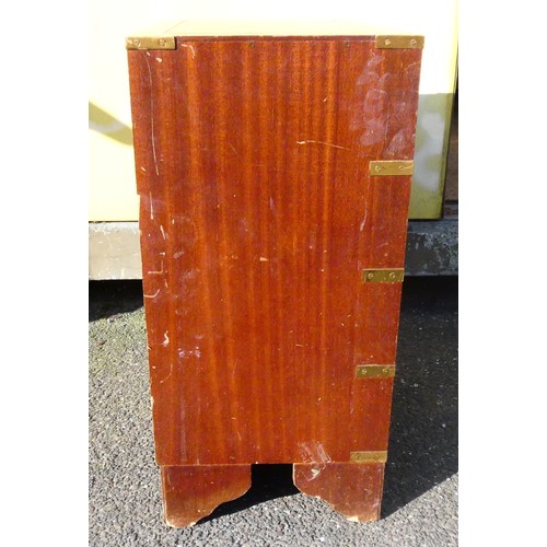 42 - A four drawer mahogany veneered storage unit with bracket feet, a brown and gold embossed leather in... 