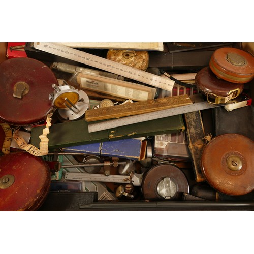 53 - A collection of early to mid twentieth century folding rulers, slide rulers, calibration rulers, tap... 