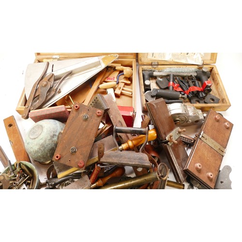 59 - A collection of early to mid twentieth century hand tools to include tin openers, small bench vice, ... 