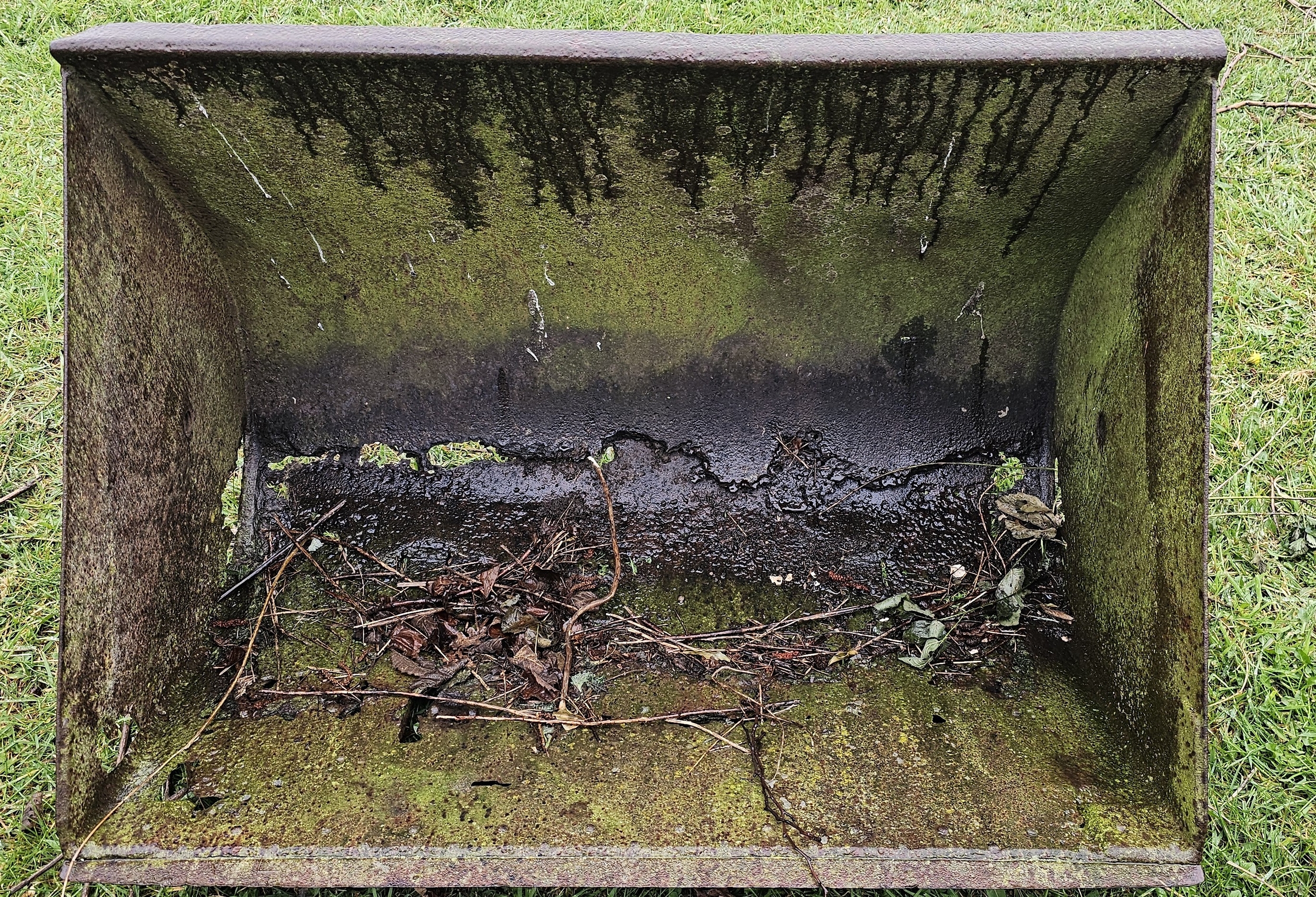 A Ferguson front loader bucket, rust holes