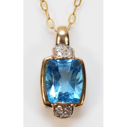 A 9ct gold blue topaz and diamond pendant on a chain, 9mm x 9mm topaz, 3.1g
