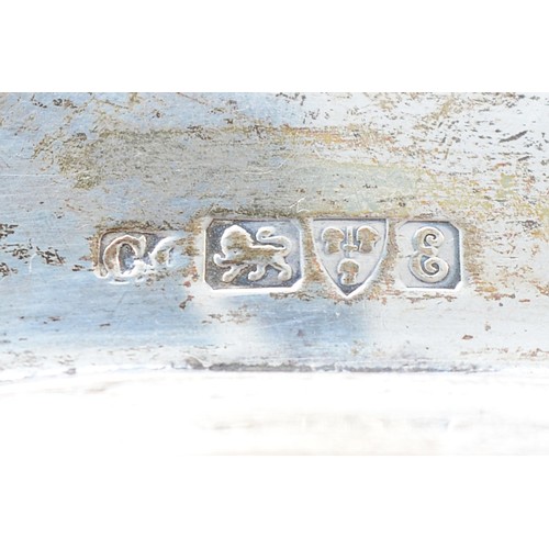 20 - An Edwardian silver tray, Chester 1905, having serpentine border and embossed Cherub scene to the ce... 