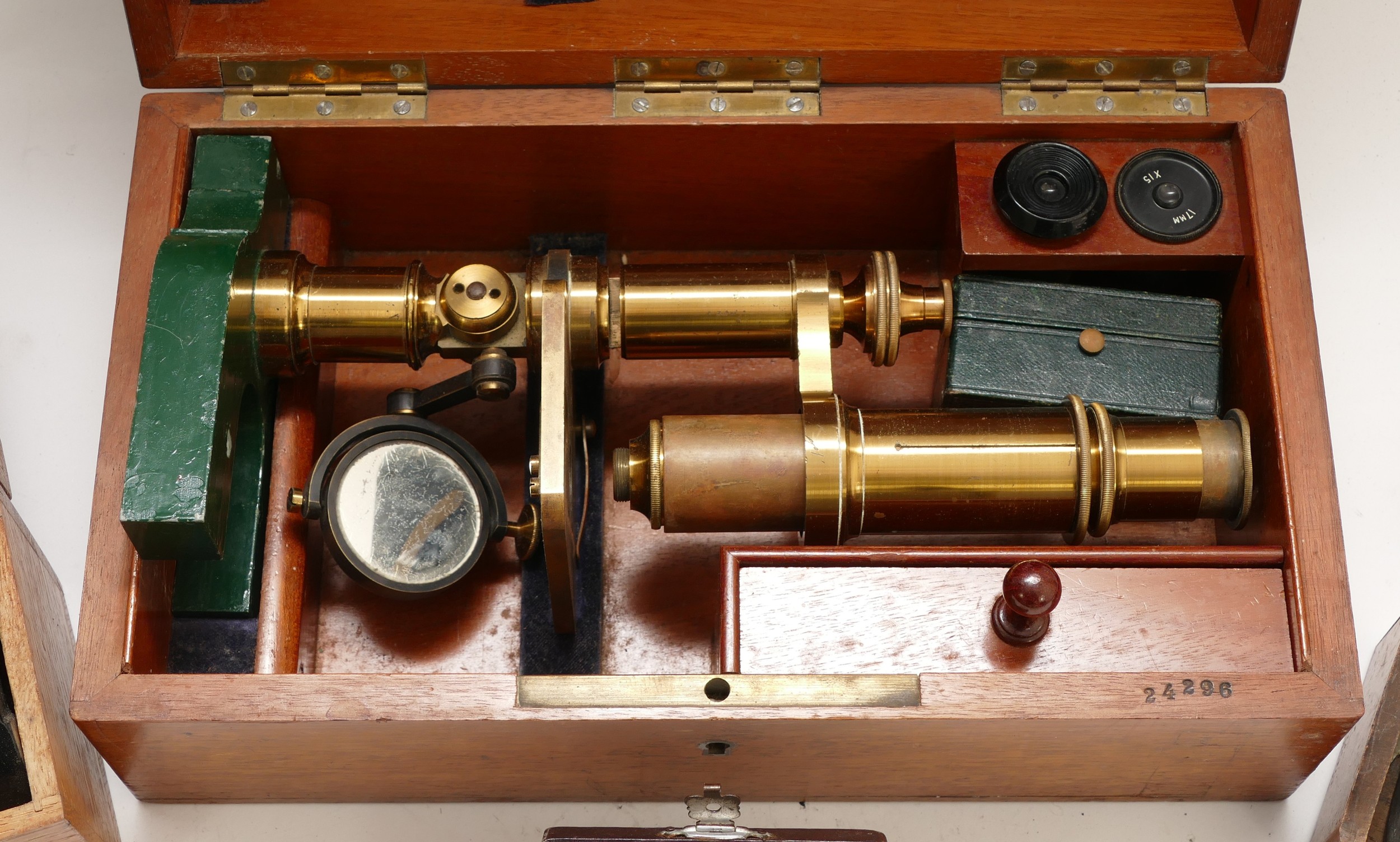 An early 20th century microscope in fitted mahogany case, together with ...