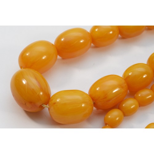 15 - A Bakelite beaded necklace. graduating bead size, largest 25mm, 78cm with two spare beads, 113g