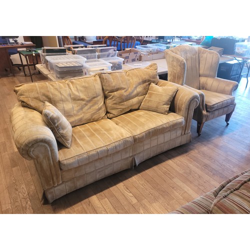 A Barker & Stonehouse 'Summerset' three seater sofa, having reversible feather filled back cushions and fibre filled seat cushions, upholstered in a light gold striped chenille fabric, W200, D95, H85, together with a matching wingback armchair. (2)