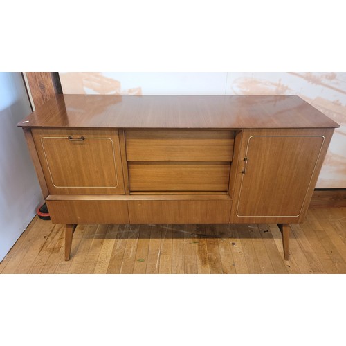 A mid 20th century Beautility teak sideboard, fitted with a central ...