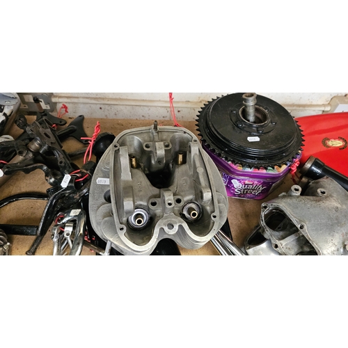 129 - A quantity of British motorcycle spares, mainly BSA, including a cylinder head pipes and a wheel