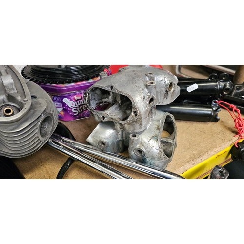 129 - A quantity of British motorcycle spares, mainly BSA, including a cylinder head pipes and a wheel