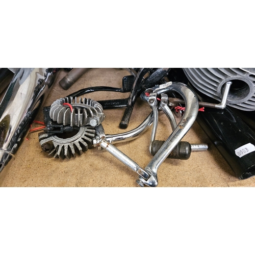 129 - A quantity of British motorcycle spares, mainly BSA, including a cylinder head pipes and a wheel