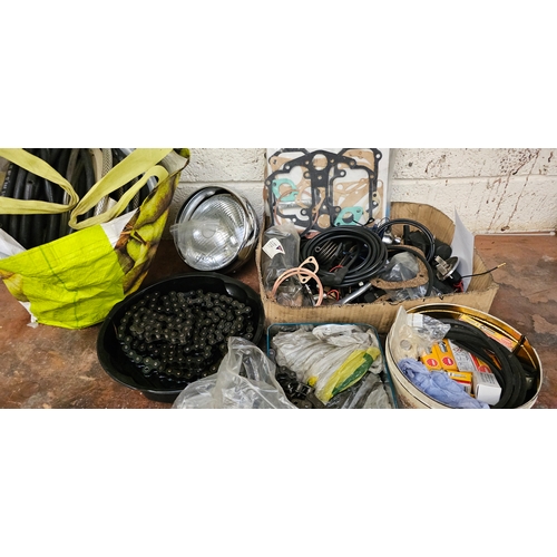 145 - A collection of Velocette Venom spares, NOS and used to include a headlamp and a new chain