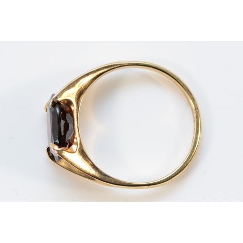 15 - A 9ct gold garnet dress ring, 10mm x 7mm garnet, London 1975, O, 2.7g
