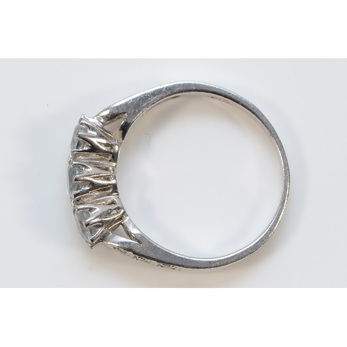 25 - A 9ct white gold blue topaz three stone ring with diamond set shoulders, L, 2.9g